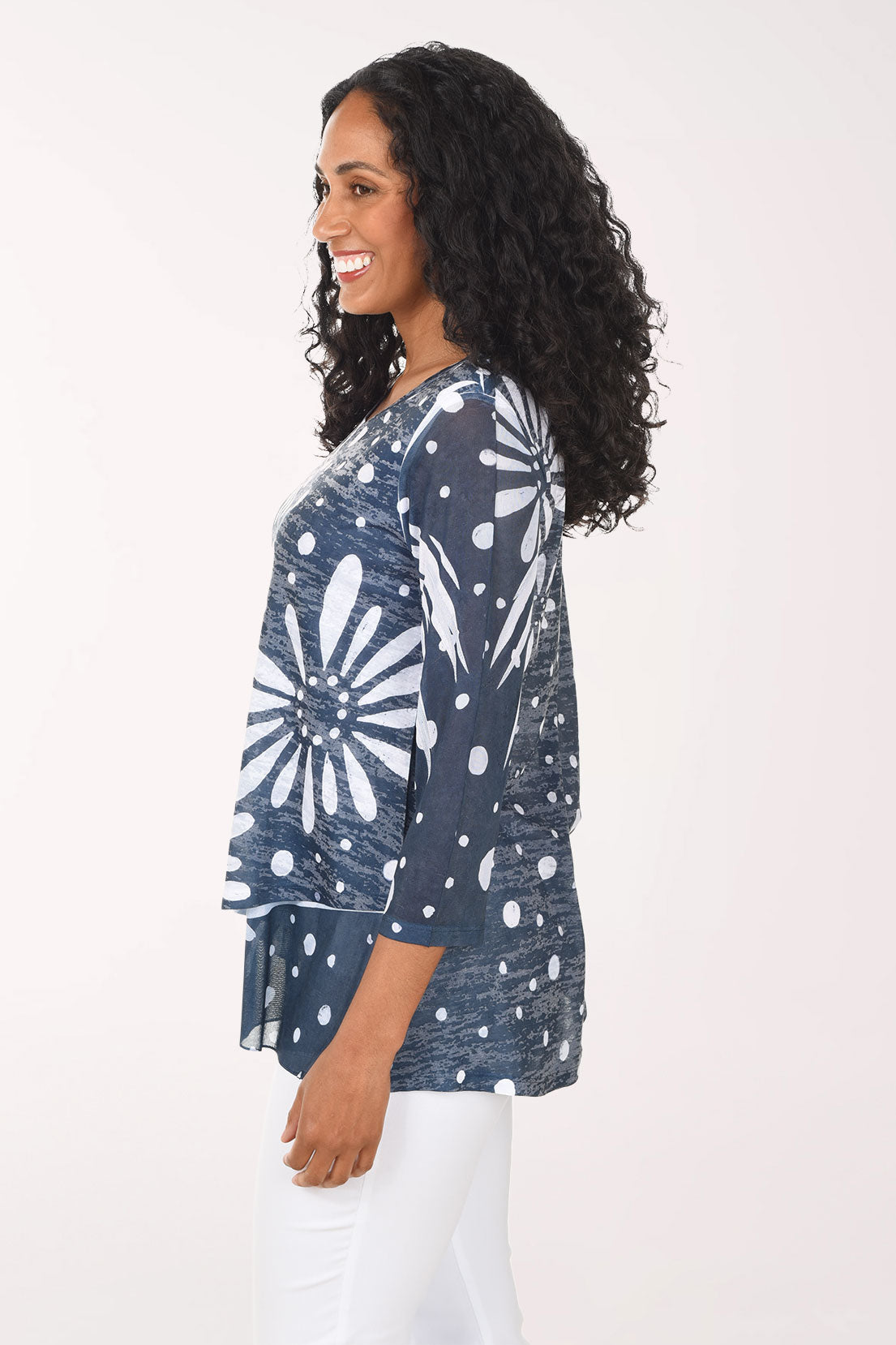 Woman wearing a blue floral patterned top on a white background