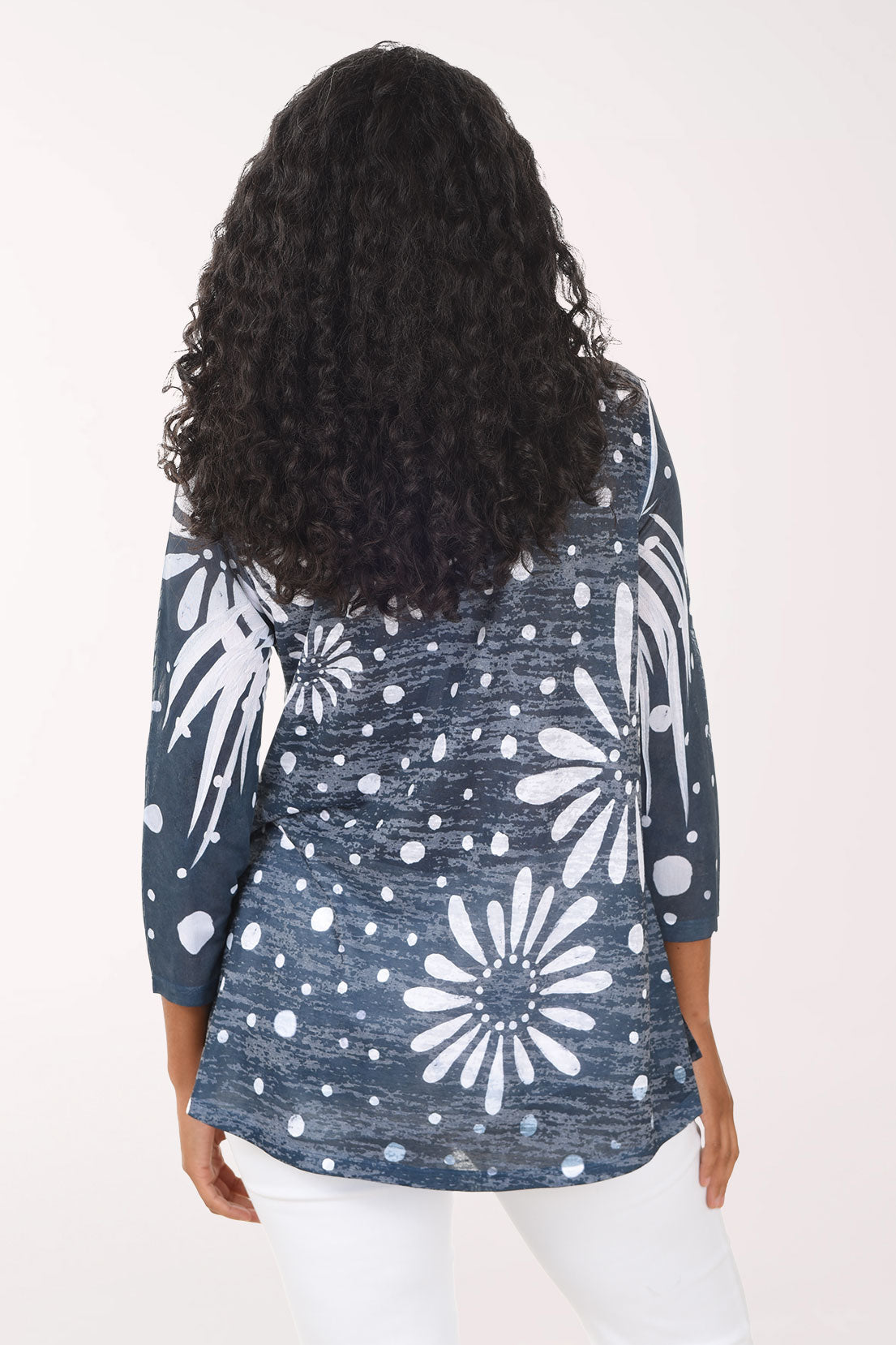 Woman wearing a blue floral patterned top on a white background