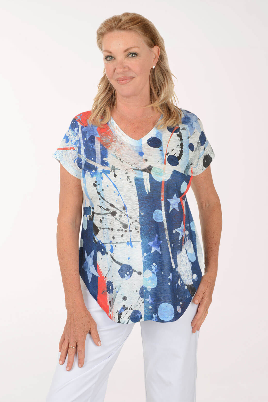 Woman wearing a colorful abstract patterned top on a white background