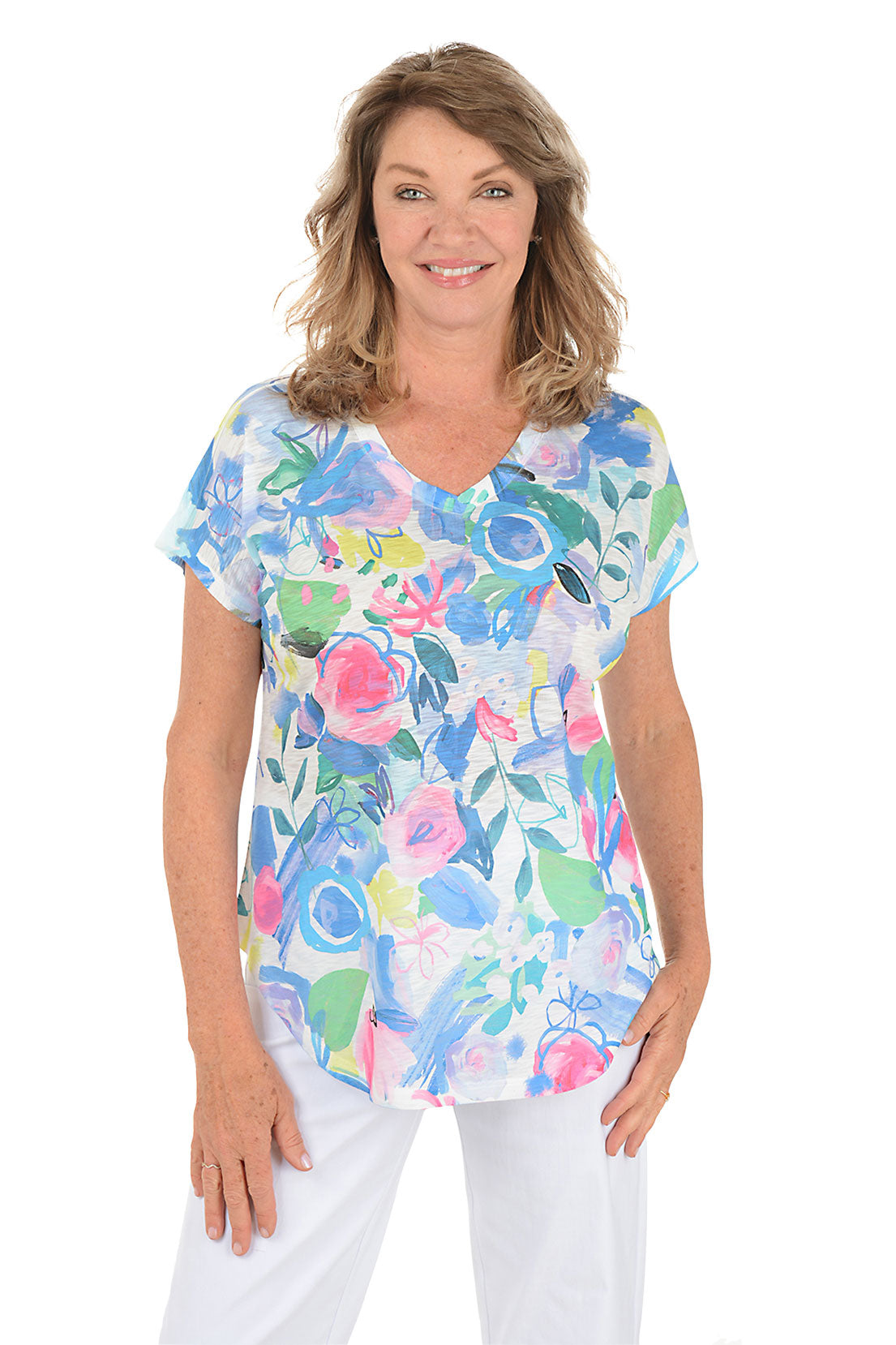 Woman wearing a white short sleeve v-neck shirt with a floral design. Second front shot.