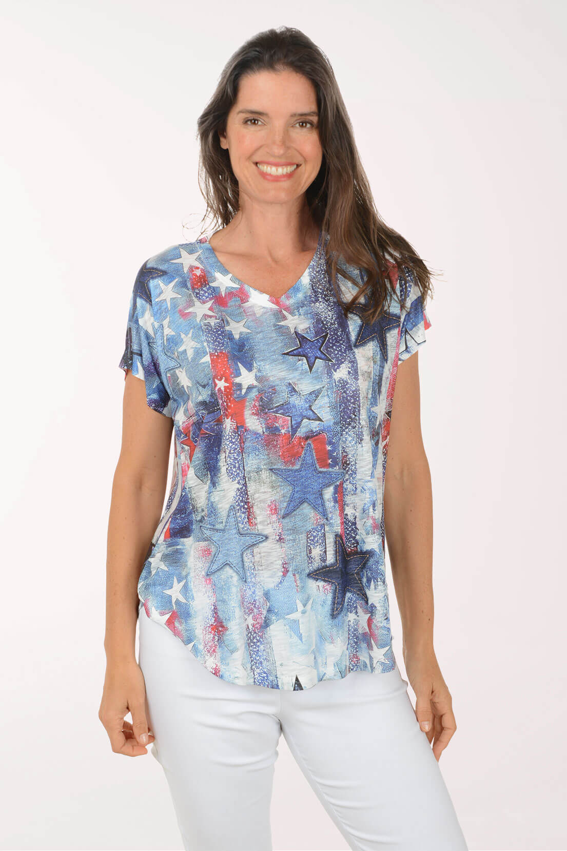 Woman wearing a colorful star-patterned top on a white background