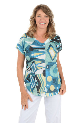 Woman wearing a colorful abstract patterned top on a white background. Second front shot.