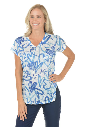 A woman wearing a blue and white short sleeve v-neck shirt with a heart design.