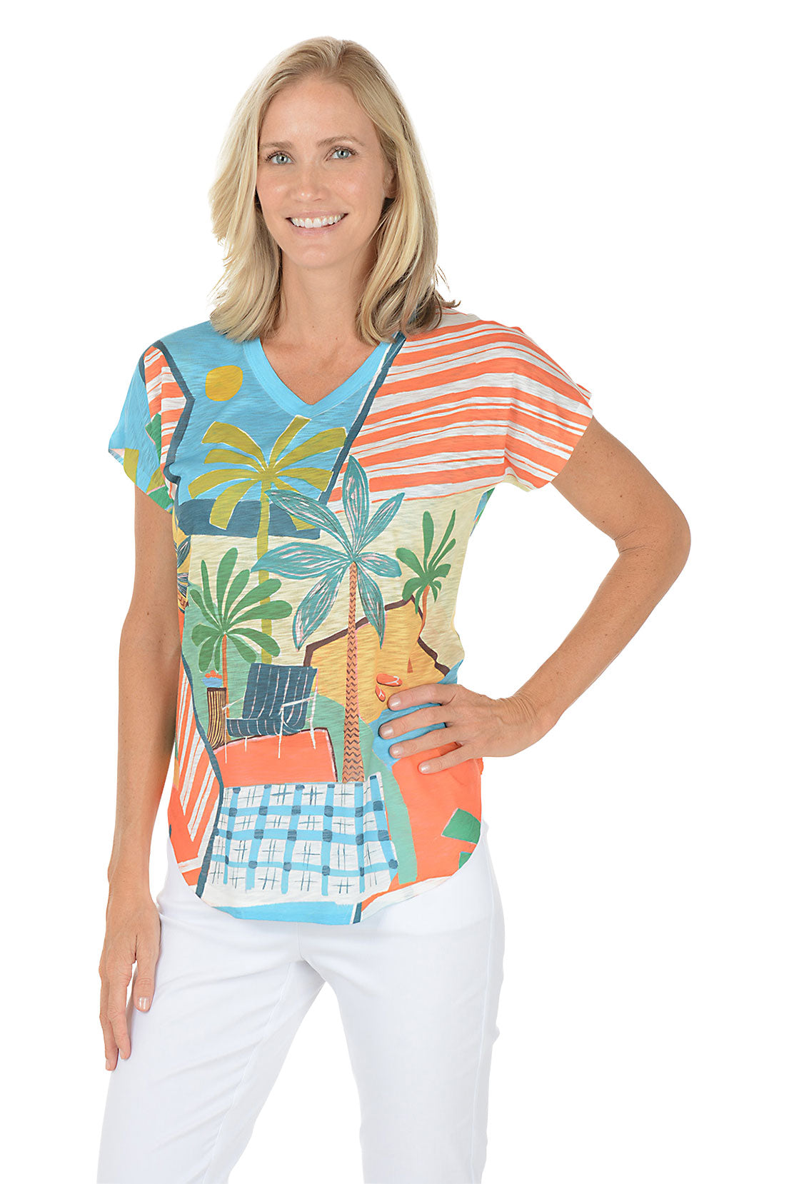 A woman wearing a multicolored short sleeve v-neck shirt with a landscape design.
