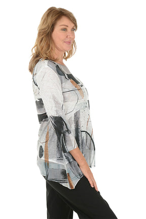 A woman wearing a 3/4 sleeve black and white shirt with an abstract pattern and flutter hem. Side shot.