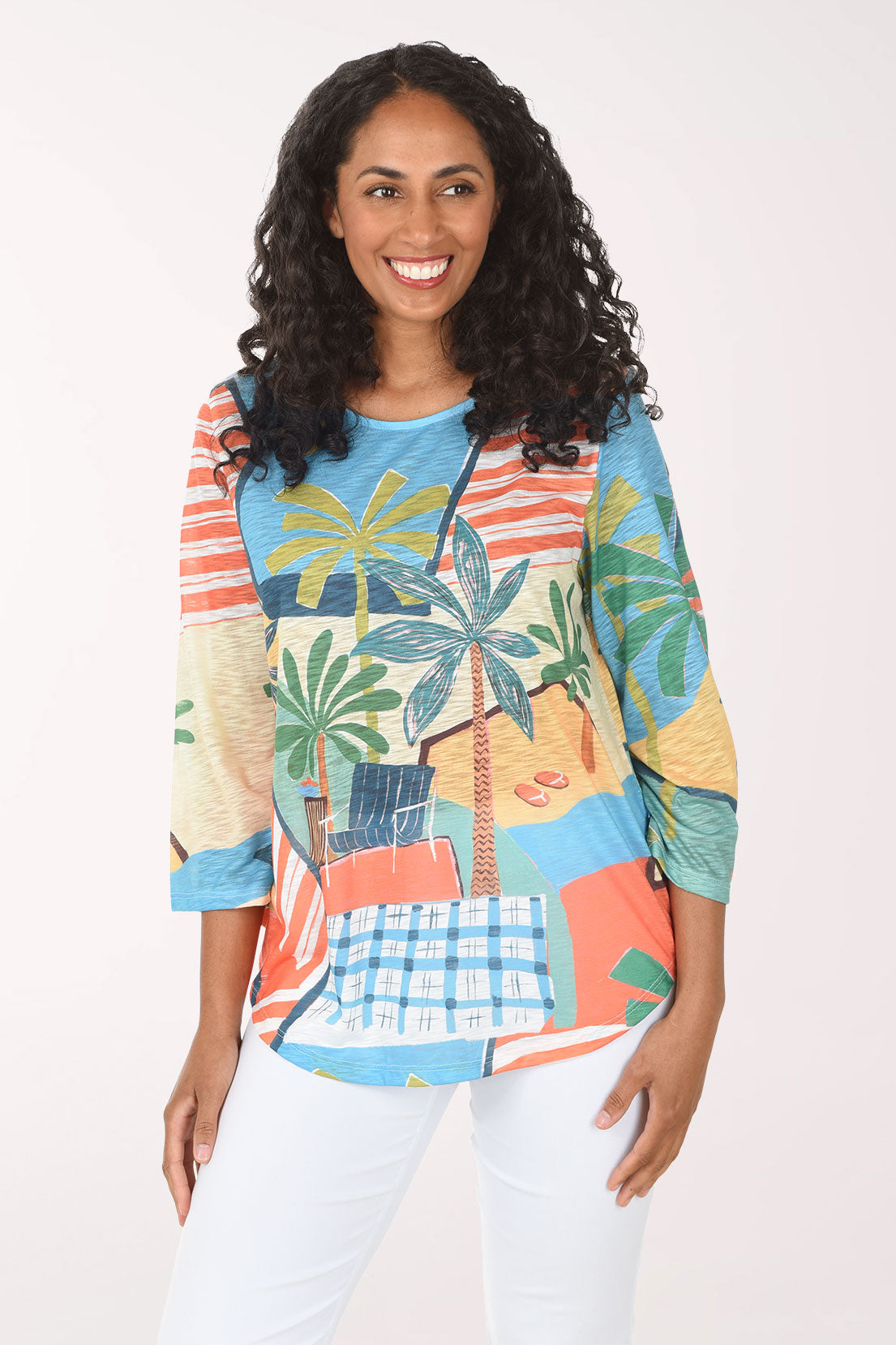 Woman wearing a colorful patterned shirt with palm tree design on a white background
