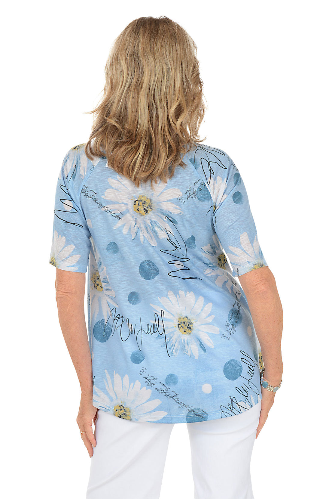 A woman wearing a blue short sleeve shirt with a daisy pattern. Back shot.