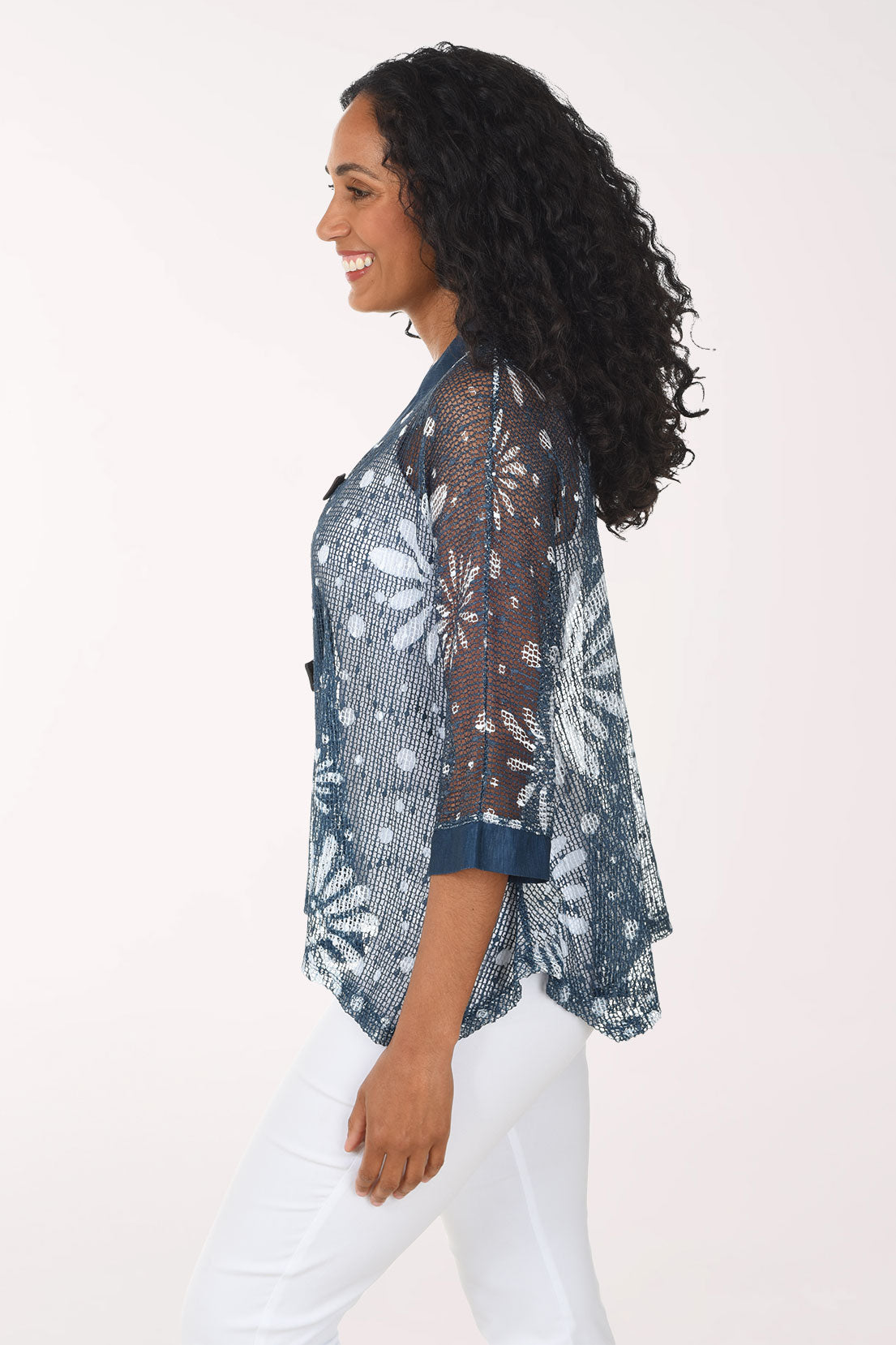 Woman wearing a patterned blouse with a white background