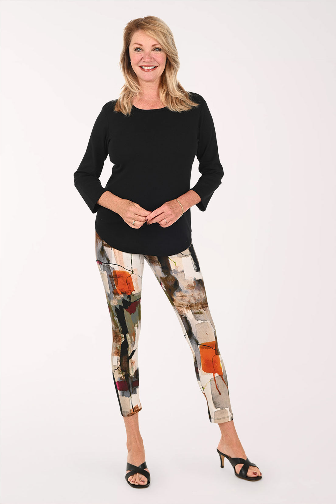 Woman wearing a black top abstract printed leggings