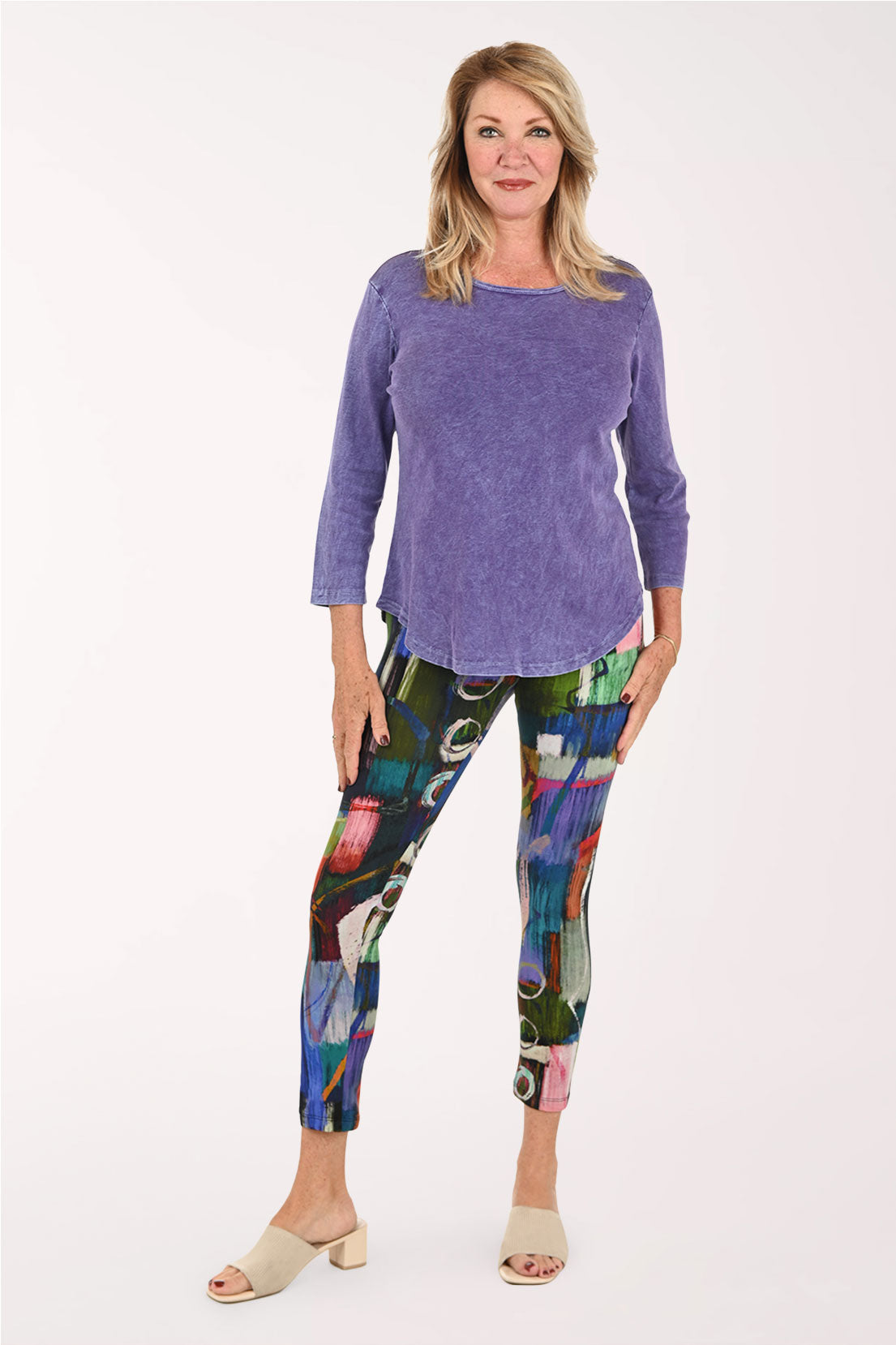Woman wearing purple shirt and abstract printed leggings