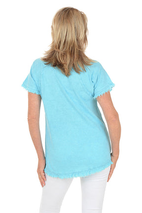 Woman wearing a light blue floral patterned top on a white background. Back shot.