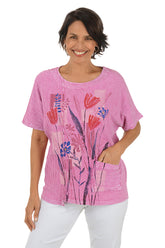 Woman wearing a pink floral-patterned shirt on a white background