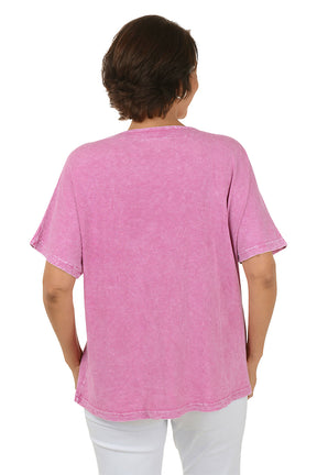 Woman wearing a pink floral-patterned shirt on a white background