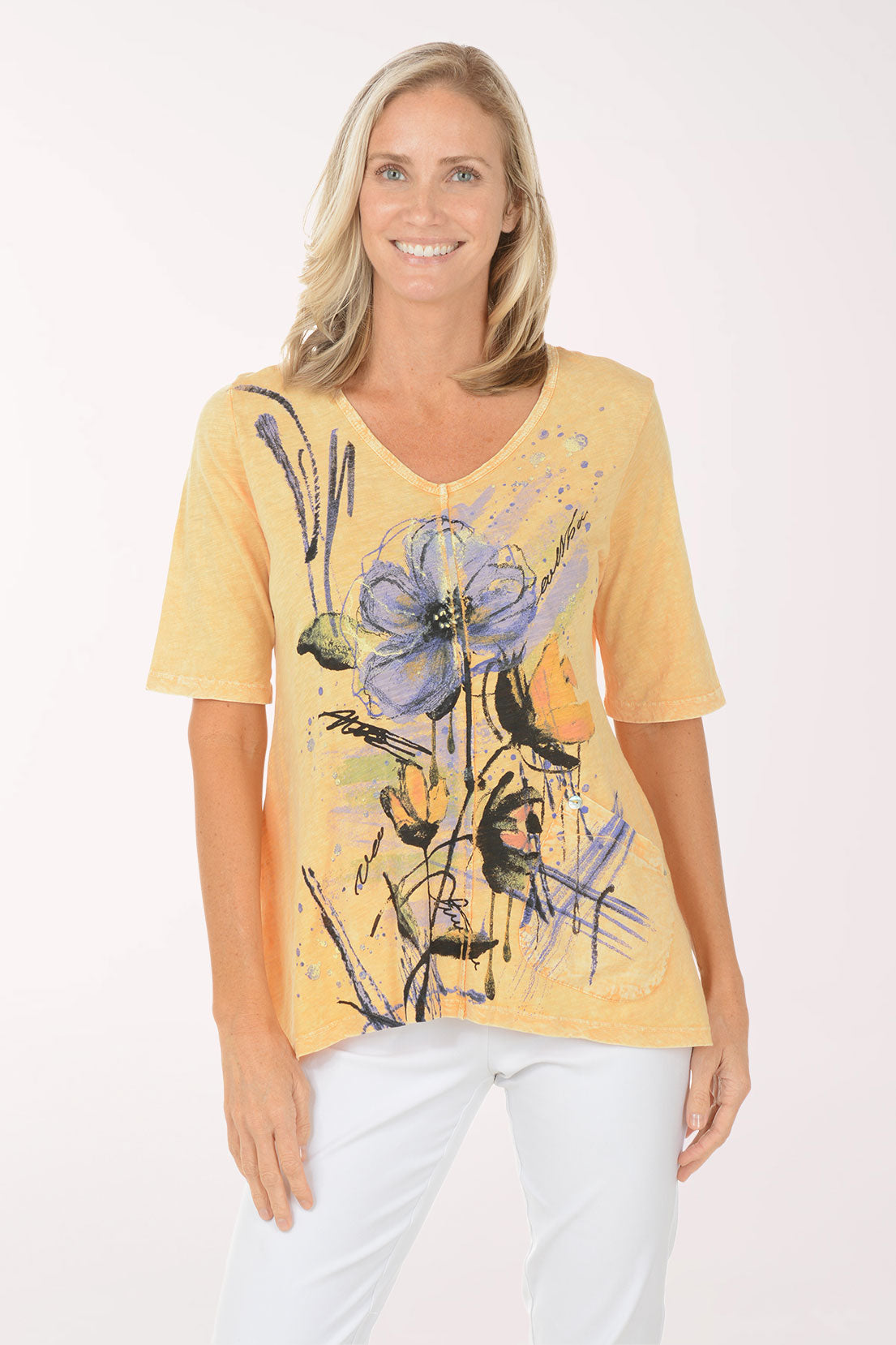 Woman wearing a yellow t-shirt with floral design on a white background