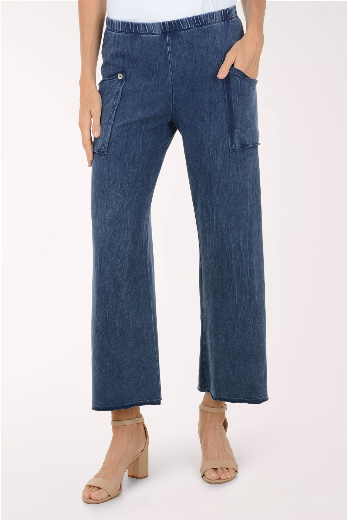 Blue denim pants worn by a person on a white background