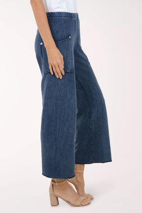 Blue denim pants worn by a person on a white background