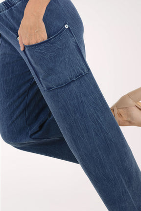 Blue denim pants worn by a person on a white background