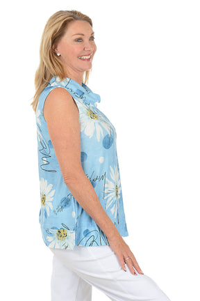 Woman wearing a sleeveless floral blouse with a white background. Side shot.