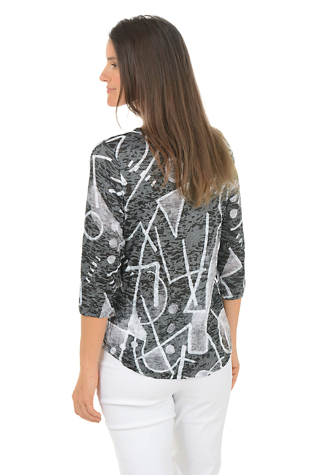 Woman wearing a black and white patterned top with white pants on a white background. Back shot.