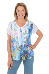 Woman wearing a colorful graphic t-shirt with a white background