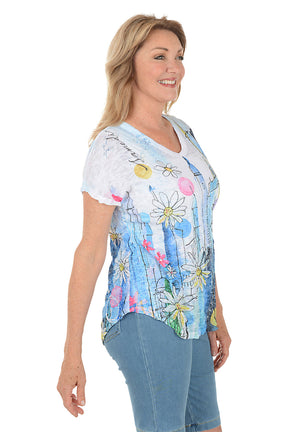 Woman wearing a colorful graphic t-shirt with a white background