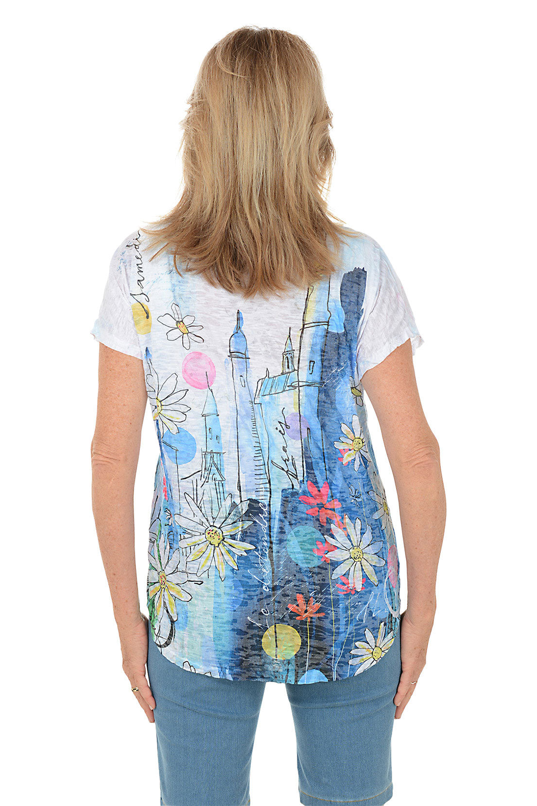 Woman wearing a colorful graphic t-shirt with a white background