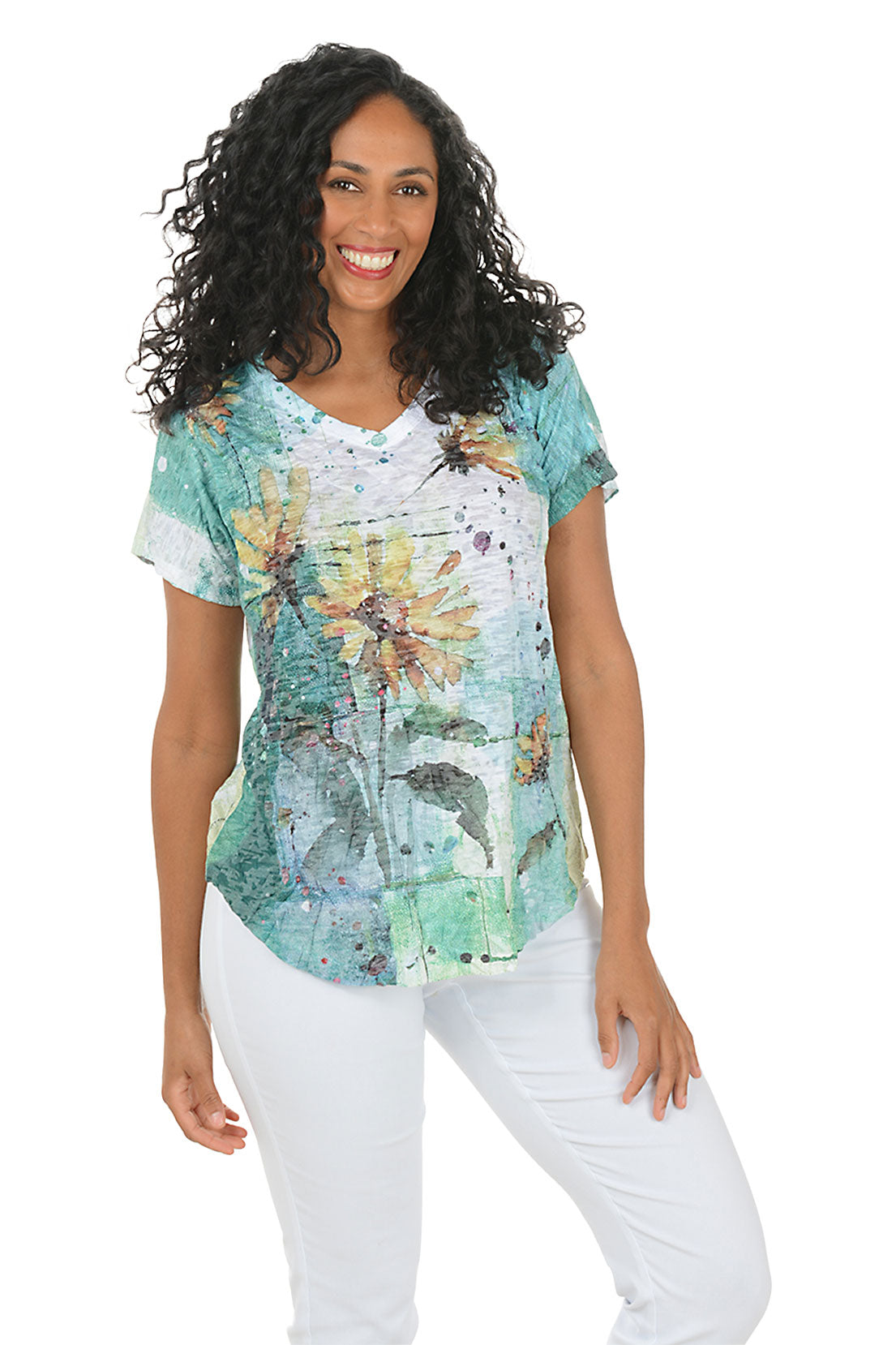 Woman wearing a floral-patterned top and white pants on a white background.