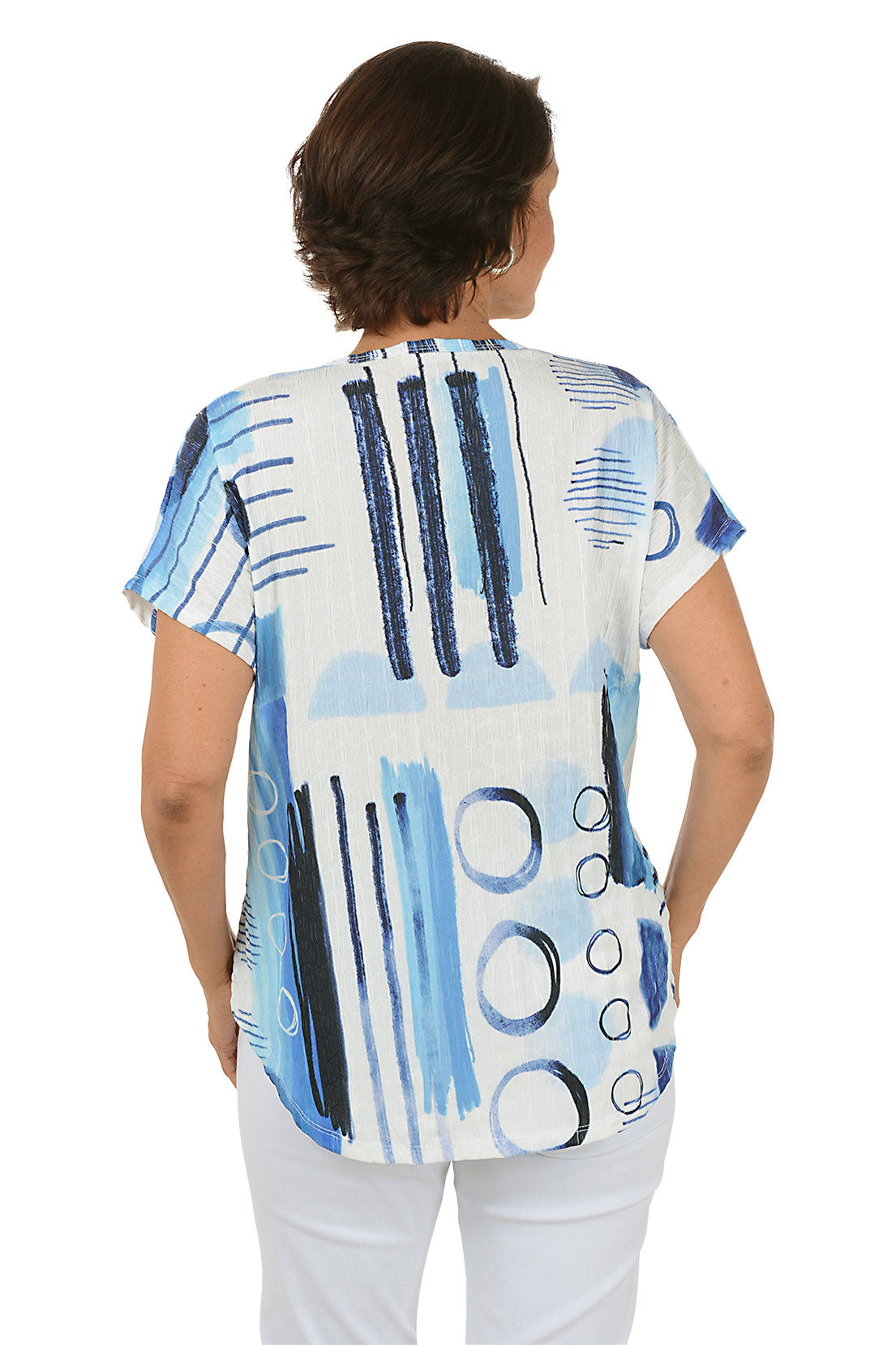 Woman wearing a blue and white abstract patterned top on a white background