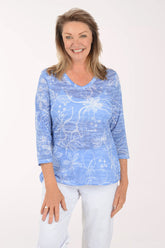 Woman wearing a blue patterned shirt on a white background