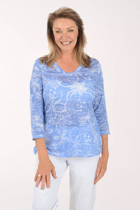 Woman wearing a blue patterned shirt on a white background