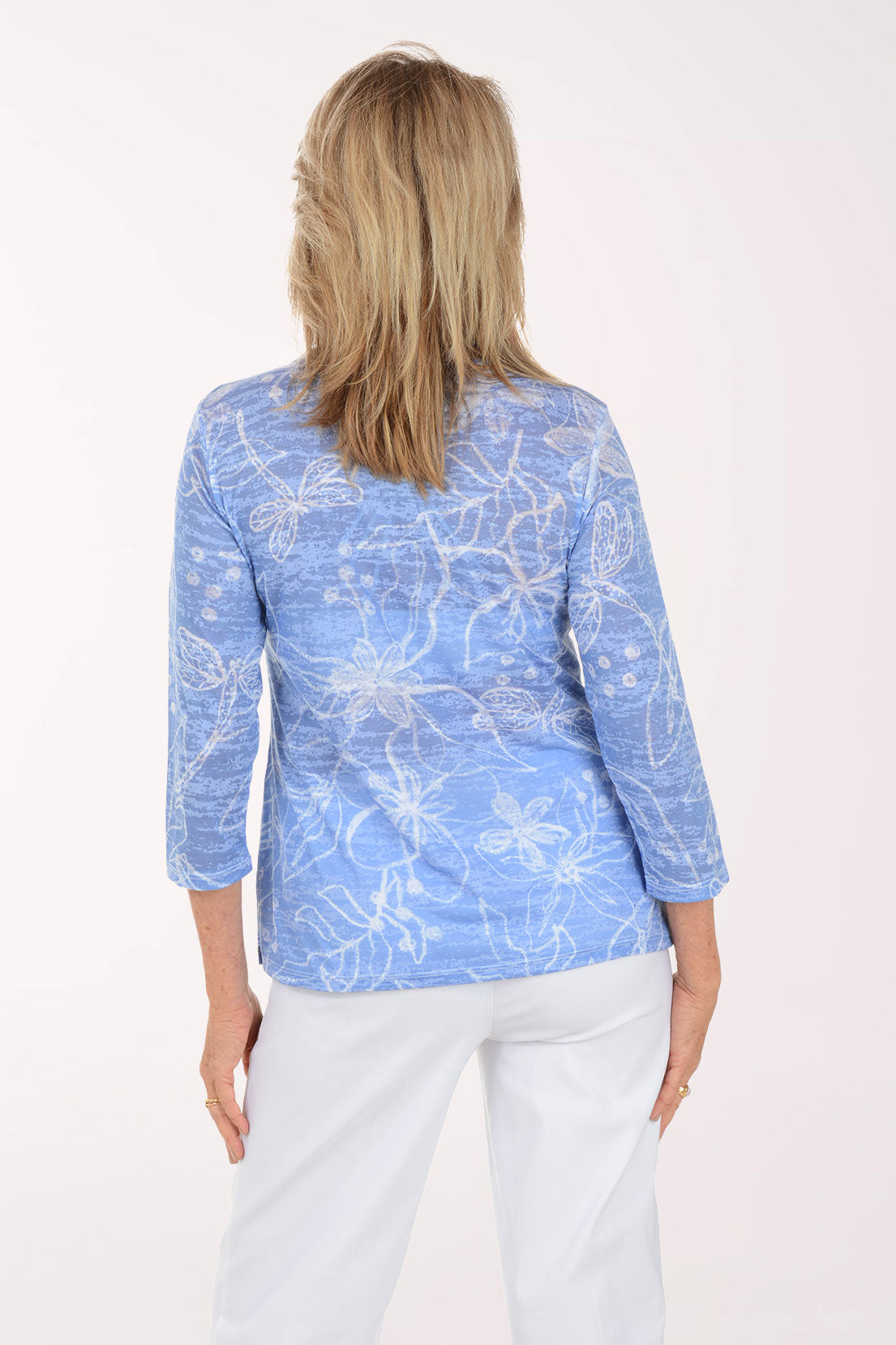 Woman wearing a blue patterned shirt on a white background