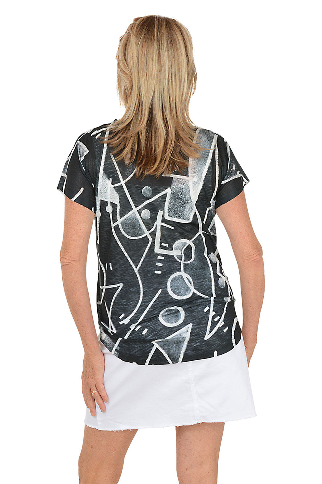 Woman wearing a black t-shirt with white abstract patterns on a white background. Back shot.