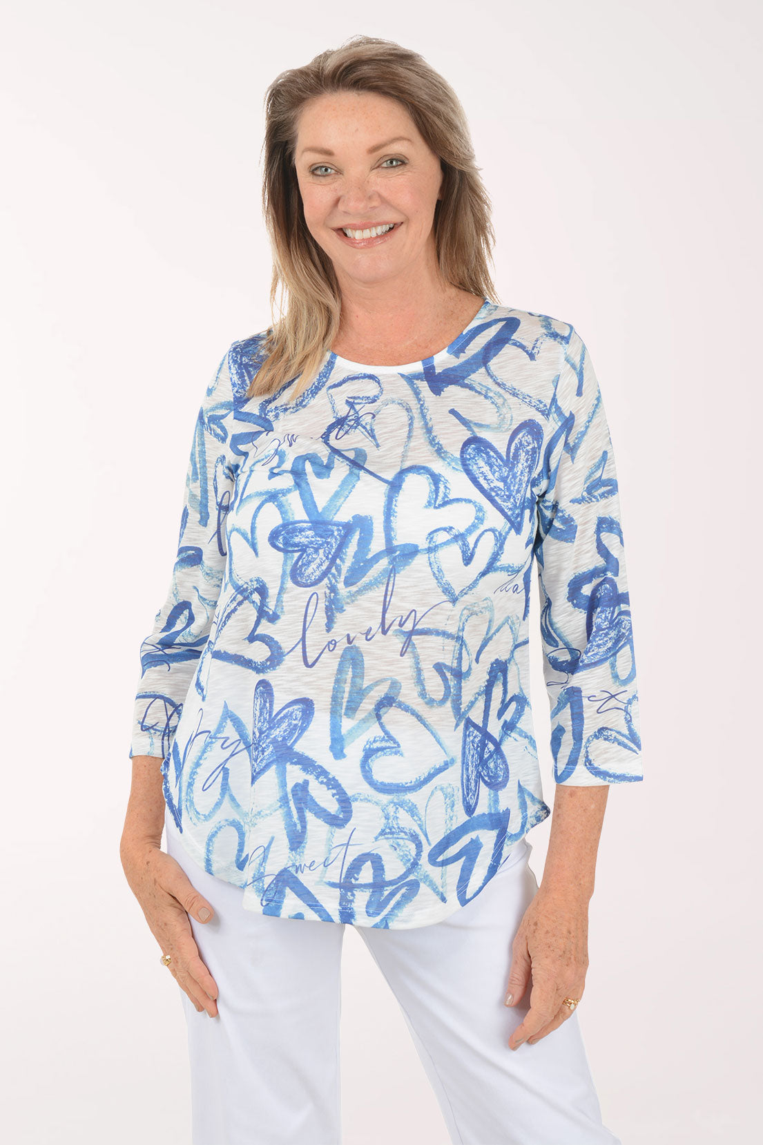 Woman wearing a blue and white patterned top on a white background