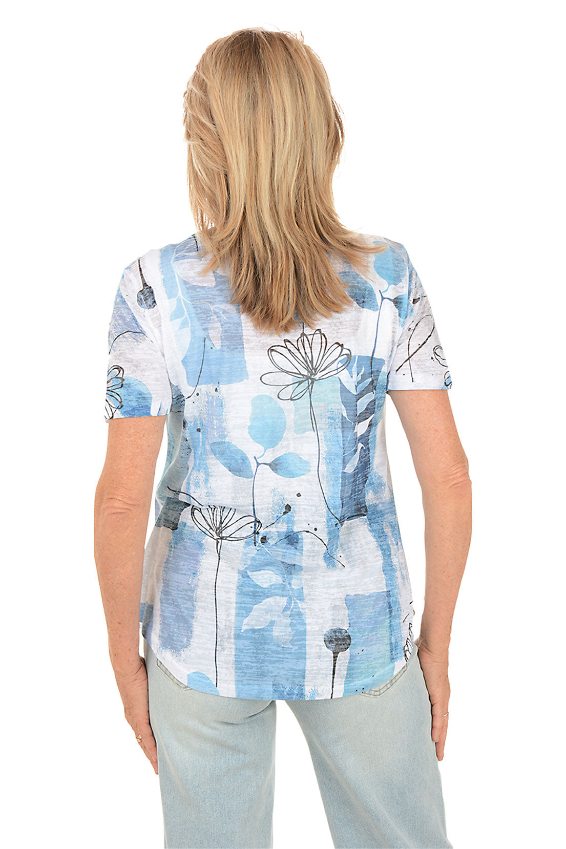 Woman wearing a blue floral patterned shirt on a white background. Back shot.