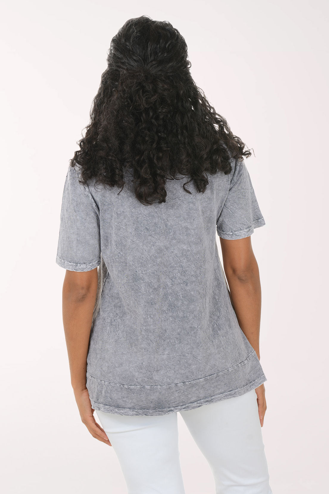 Woman wearing a patterned gray shirt on a white background