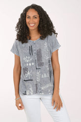 Woman wearing a patterned gray shirt on a white background