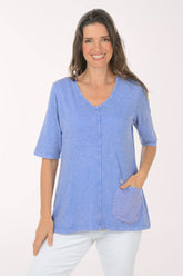 Woman wearing a blue 3/4 sleeve top.