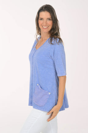 Woman wearing a blue 3/4 sleeve top.