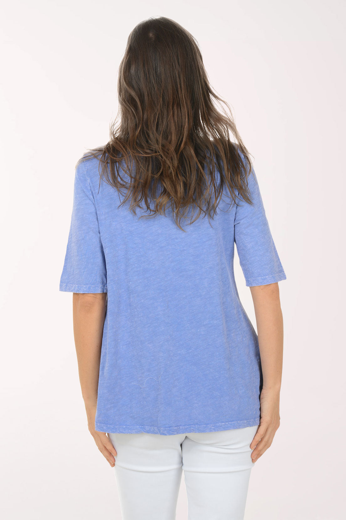 Woman wearing a blue 3/4 sleeve top.