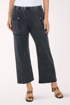 Person wearing dark denim pants on a white background