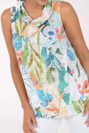 Woman wearing a colorful floral sleeveless top against a white background