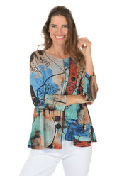 Woman wearing a colorful patterned top on a white background.