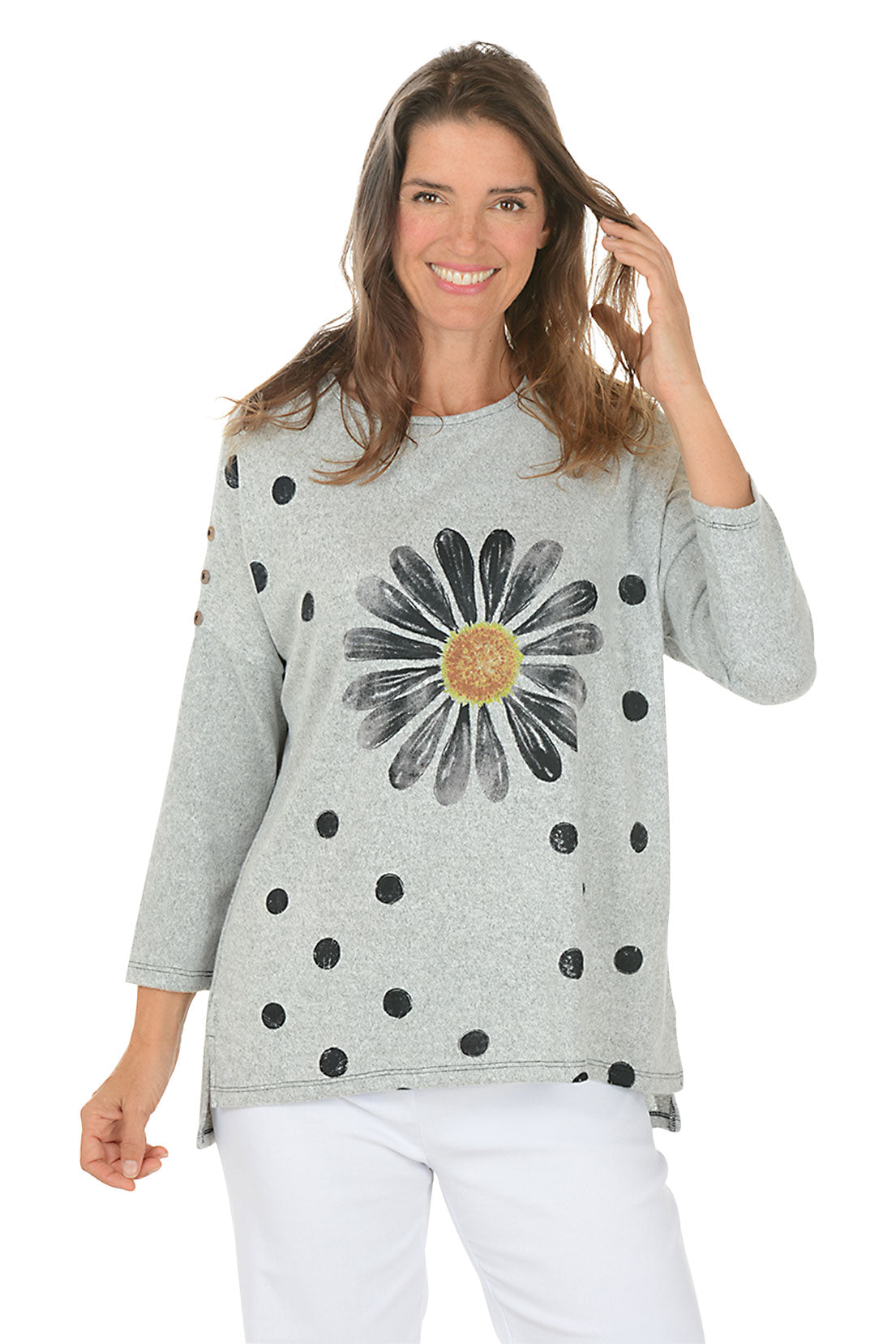 Woman wearing a gray sweater with a floral design on a white background