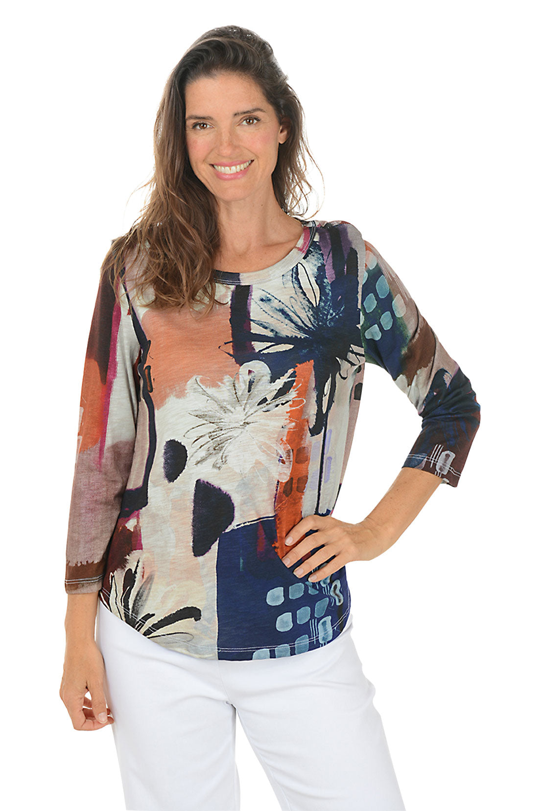 Woman wearing a colorful floral-patterned top on a white background.