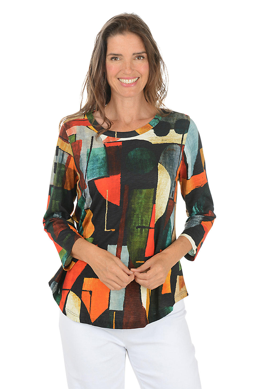 Woman wearing a colorful abstract patterned top on a white background.