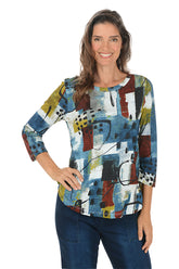 Woman wearing a colorful abstract patterned top on a white background.
