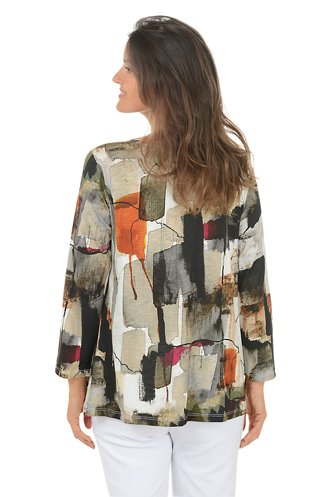 Woman wearing a colorful patterned jacket on a white background. Back shot.