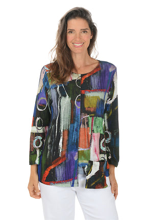 Woman wearing a colorful abstract patterned top on a white background.