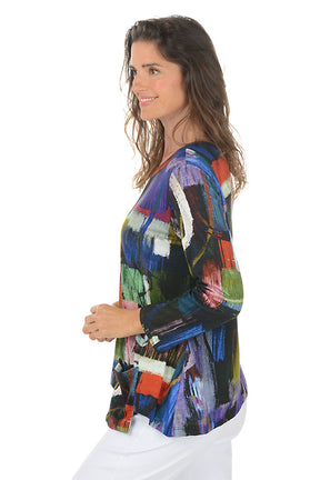 Woman wearing a colorful abstract patterned top on a white background. Side shot.
