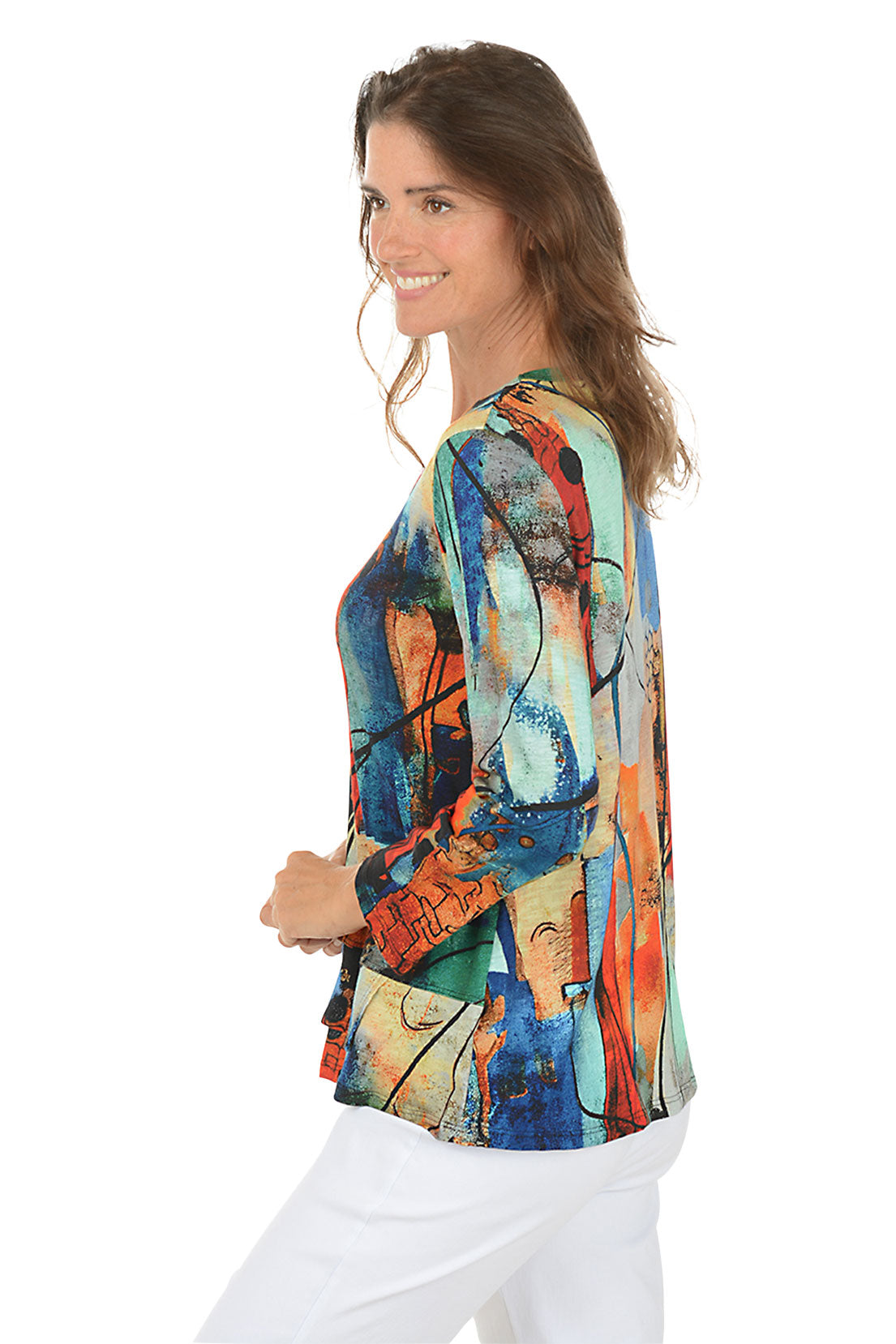 Woman wearing a colorful abstract patterned top on a white background. Side shot.